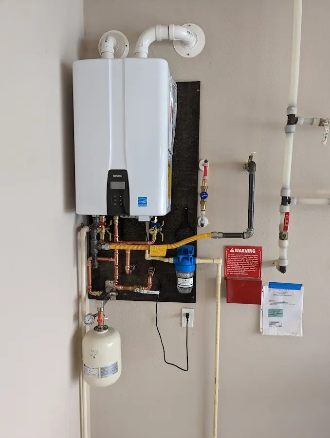 Professional plumber installing copper piping in a Lynn home